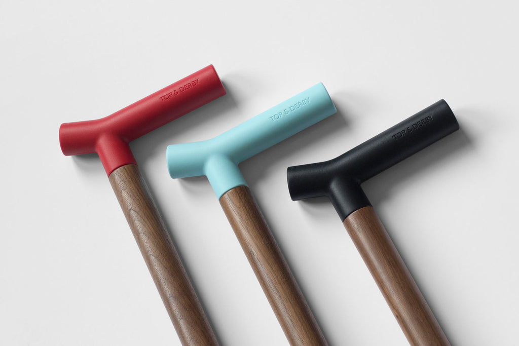 three modern walnut walking cane handles in red, blue and black